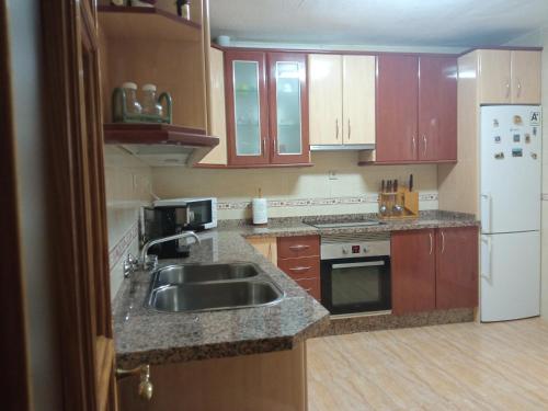 a kitchen with a sink and a refrigerator at Casa Pinos in Siles