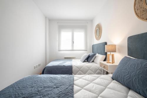 a bedroom with two beds and a window at EnjoyGranada EMIR 4C + Parking in Granada