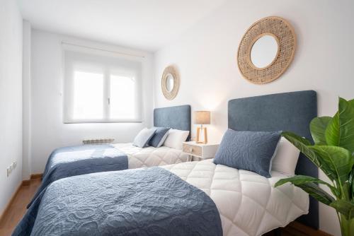 a bedroom with two beds and a mirror on the wall at EnjoyGranada EMIR 4C + Parking in Granada