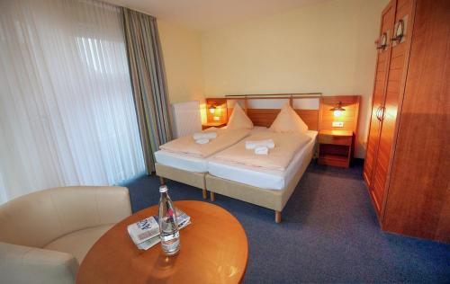a hotel room with a bed and a table at Haus Weida in Breege