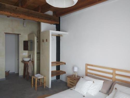 a bedroom with a bed and a staircase in it at Casa Buscareta in Montán