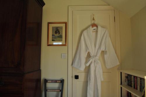 a robe hanging on a door in a room at Rose Cottage in Tunstall