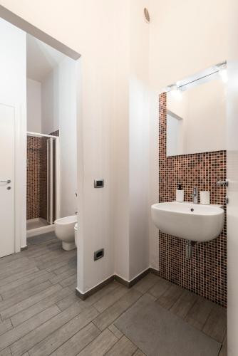 a bathroom with a sink and two toilets at The Beautiful Pisa in Pisa