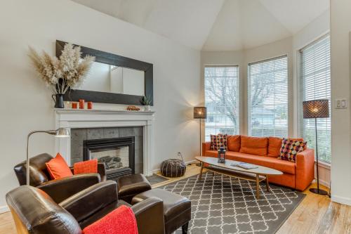 a living room with orange furniture and a fireplace at Sunset Beach House in Seaside
