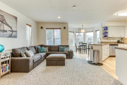 a living room with a couch and a kitchen at Sunset Beach House in Seaside