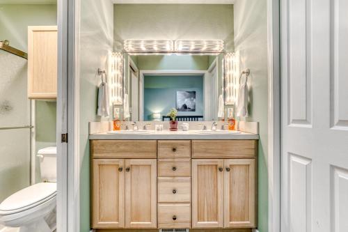 a bathroom with a sink and a toilet and a mirror at Sunset Beach House in Seaside