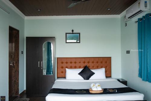 a bedroom with a large bed with a basket on it at Reunion Ocean Tides in Udupi