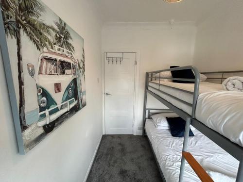a bedroom with a bunk bed and a picture of a van at Light And Spacious Highcross Apartment in Poulton le Fylde