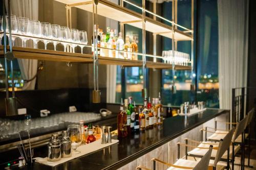 a bar in a restaurant with a view of the city at Best Western Chatuchak in Bangkok