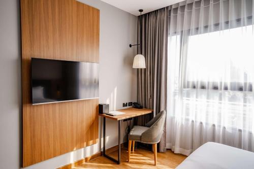 a hotel room with a desk and a television at Best Western Chatuchak in Bangkok