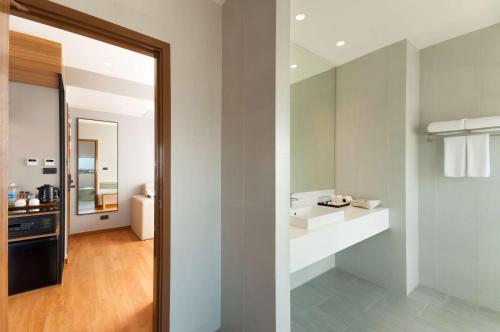 a bathroom with a sink and a mirror at Best Western Chatuchak in Bangkok