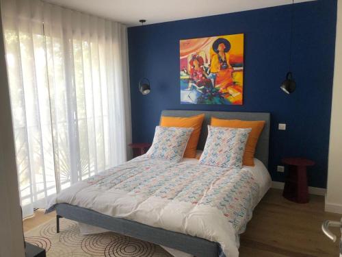 um quarto com uma cama com uma parede azul em Villa Francine em Bouc-Bel-Air