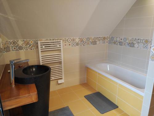 a bathroom with a sink and a bath tub at Chambre d'hôtes Seiz Breur in Lancieux