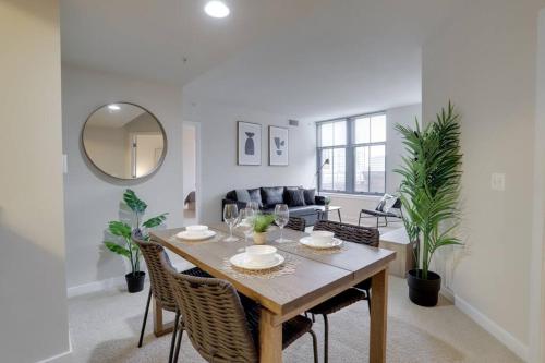a living room with a wooden table and chairs at Upscale Comfort Next to Metro and Dining in Arlington