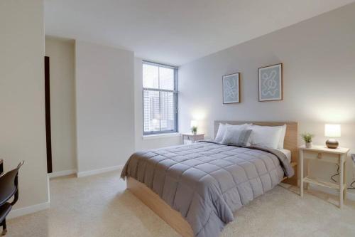 a bedroom with a large bed and a window at Upscale Comfort Next to Metro and Dining in Arlington