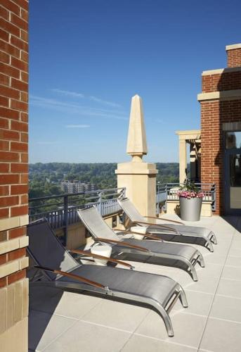 a row of lounge chairs sitting on a roof at Upscale Comfort Next to Metro and Dining in Arlington