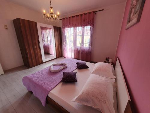 a small bedroom with a bed and a mirror at Villa Isabella with private heated pool in Kaštela