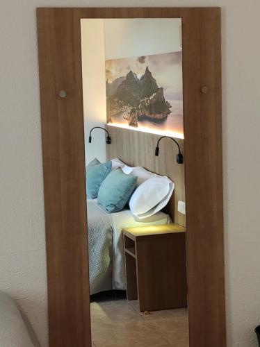 a bedroom with a bed and a painting on the wall at Hostal Nadal in Sóller
