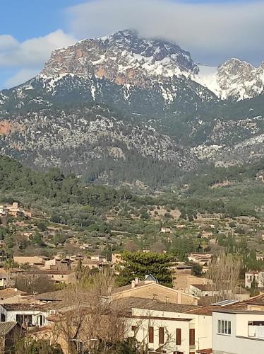 a mountain in the distance with a town and houses at Hostal Nadal in Sóller