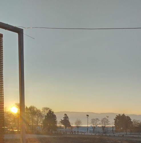 a view of the sunset from a window at Marko Apartments in Struga