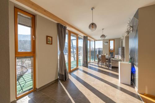 um corredor com janelas grandes e uma sala de jantar em Residenz am Aichwaldsee - mountainview and near lake em Unteraichwald