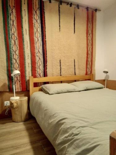 a bedroom with a bed and a window with curtains at Casa do Carregal in Braga