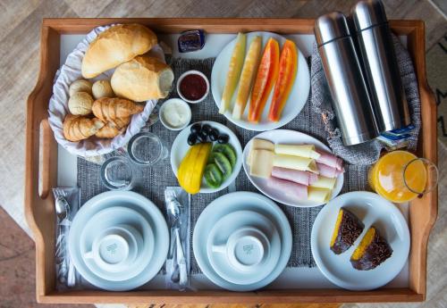 a tray of food with different types of foods at Pousada Alpes da Mantiqueira in Monte Verde