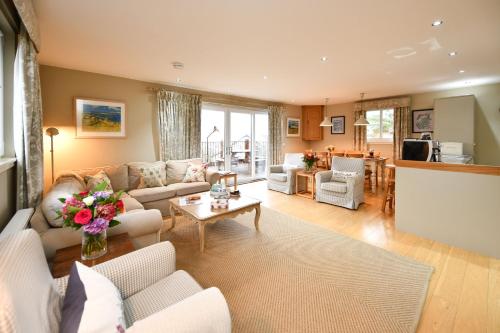 a living room with a couch and a table at Cedar Lodge in Portpatrick