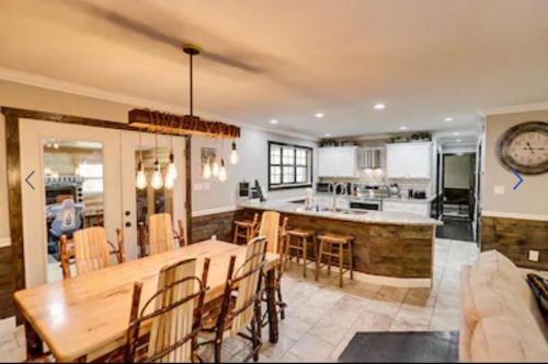 a large kitchen with a wooden table and a dining room at Dollywood Vacation Retreat in Pigeon Forge