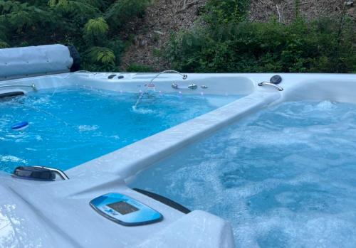 a hot tub with blue water in a backyard at Dollywood Vacation Retreat in Pigeon Forge