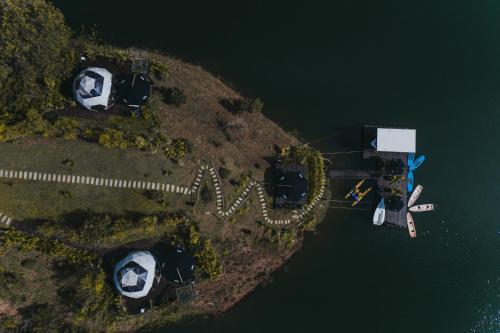 an aerial view of a dock with boats in the water at Domus Glamping Guatapé in Guatapé