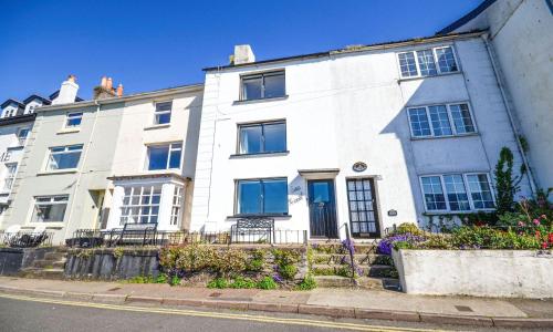 a white house on the side of a street at Sea Nook in Brixham