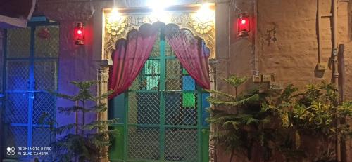 a door with a curtain on a wall with lights at Queen Room @ Shangri-Li in Jodhpur