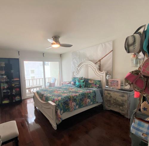 - une chambre avec un lit et un ventilateur de plafond dans l'établissement Bay Beach Bungalow, à San Diego