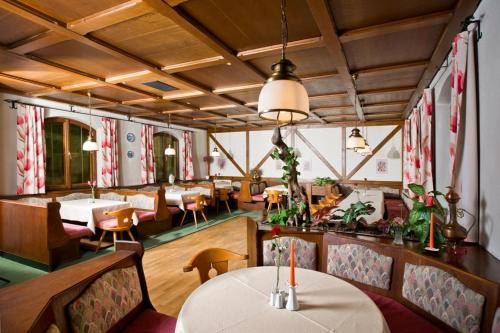 a restaurant with a table and chairs and tables at Gasthof Dangl in Wimpassing an der Pielach