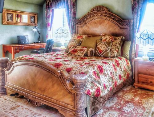 a bedroom with a large bed with a wooden frame at The Victorian Spa Retreat in Port Angeles
