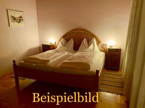 a bed in a bedroom with two lights on at Hof zur Steinwänd in Micheldorf in Oberösterreich
