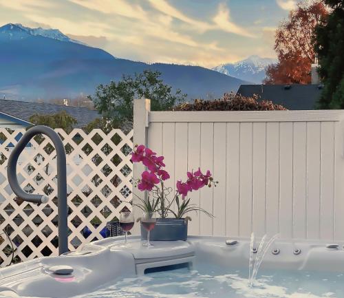 um lavatório com copos de vinho e flores numa cerca em The Victorian Spa Retreat em Port Angeles