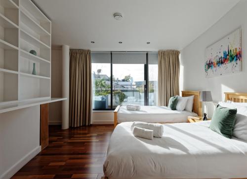 a hotel room with two beds and a window at Farringdon Laceby apartments in London