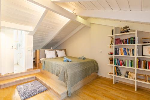 a bedroom with a bed and a book shelf at Something different in Chalkida in Kánithos