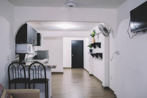 a kitchen with a table and chairs in a room at Departamento Mazatlán in Mazatlán