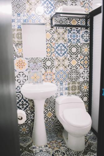 a bathroom with a toilet and a sink at Departamento Mazatlán in Mazatlán