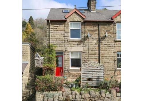 a brick house with a red door in front of it at Gorgeous 3 bed house in Matlock + Garden ‘lookout’ in Matlock
