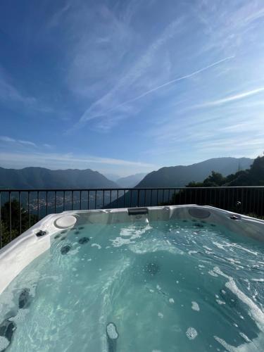 a hot tub with a view of the mountains at Hotel Paradiso Como in Brunate