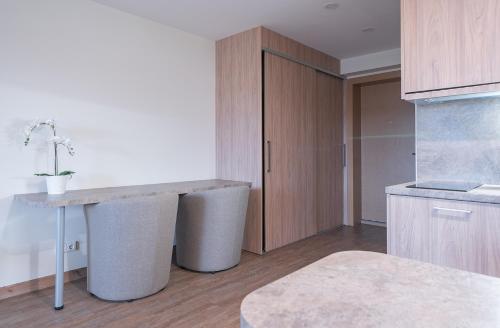 a kitchen with a counter and a table in it at Gynėjų Self Check-in Apartments - Lollo Stay in Vilnius