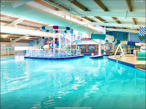 a large indoor swimming pool with a water slide at The Sherbourne in Selsey