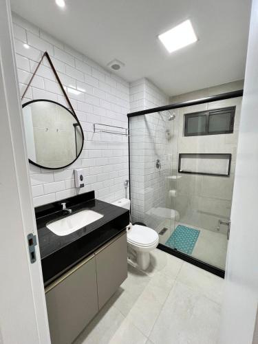 a bathroom with a sink and a toilet and a shower at "Vivendo no Paraíso" - Flat C/Suíte no Centro in Porto De Galinhas
