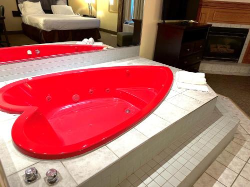 a red bath tub in a hotel room at Super 8 by Wyndham Niagara Falls by the Falls in Niagara Falls