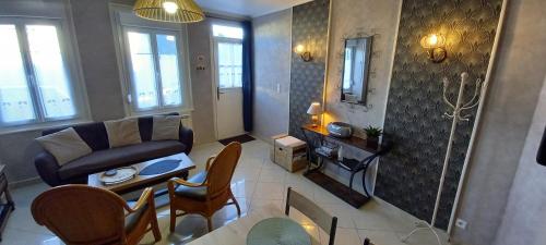 a living room with a couch and a table at L'ESTRAN in Saint-Valery-sur-Somme