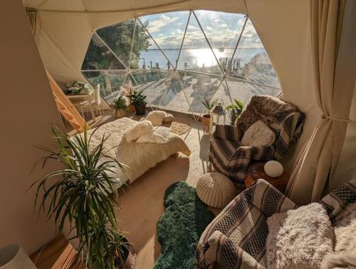 a room with a tent with a large window at beautiful located dome in Wapnica